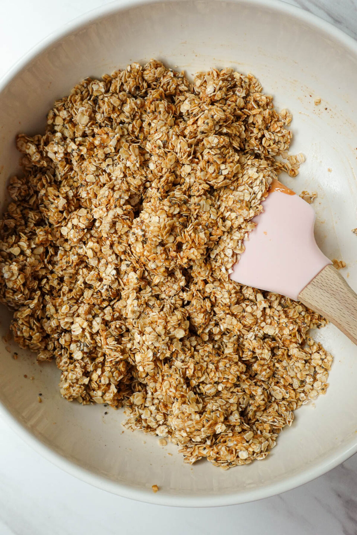 Mixing ingredients for peanut butter granola.