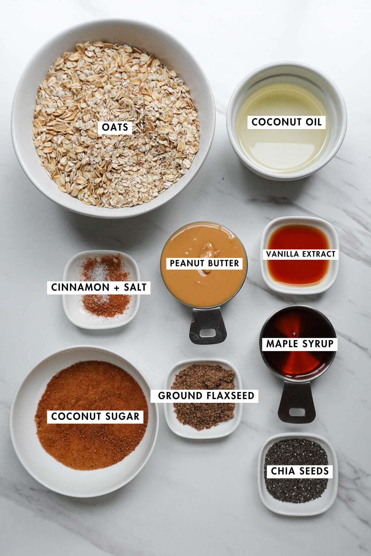Labeled ingredients on a table to make peanut butter granola.
