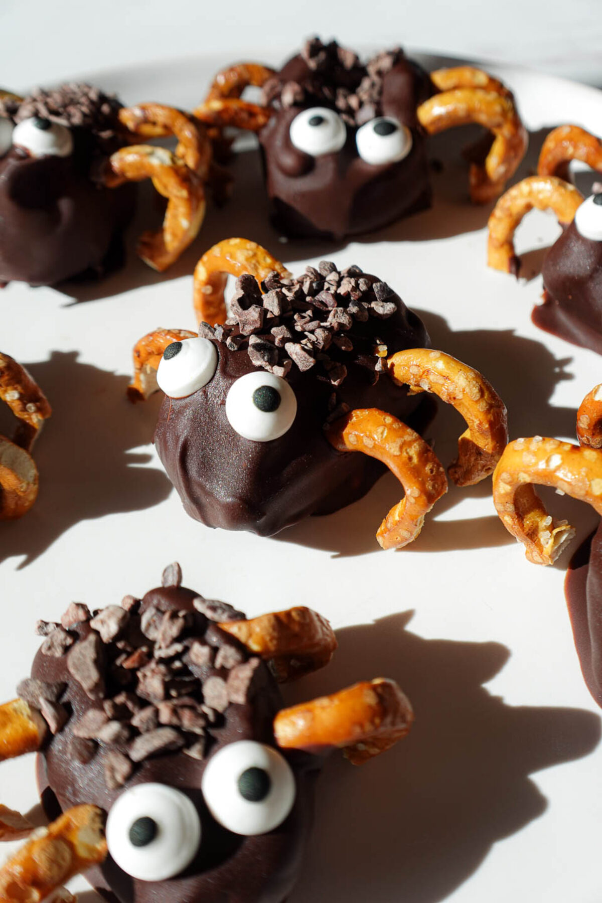 Stuffed date spiders decorated with candy eyes and pretzel legs. A healthy halloween treat!