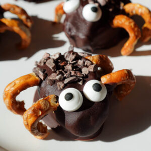 close up of stuffed date spiders decorated with candy eyes and pretzel legs. A healthy halloween treat!