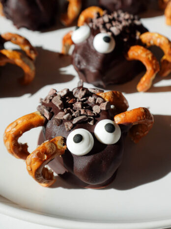 close up of stuffed date spiders decorated with candy eyes and pretzel legs. A healthy halloween treat!