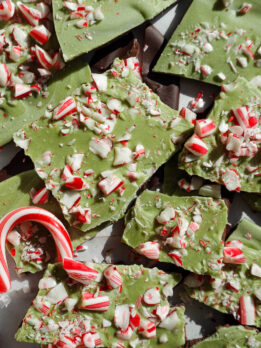 Vegan matcha peppermint bark broken into pieces with candy canes