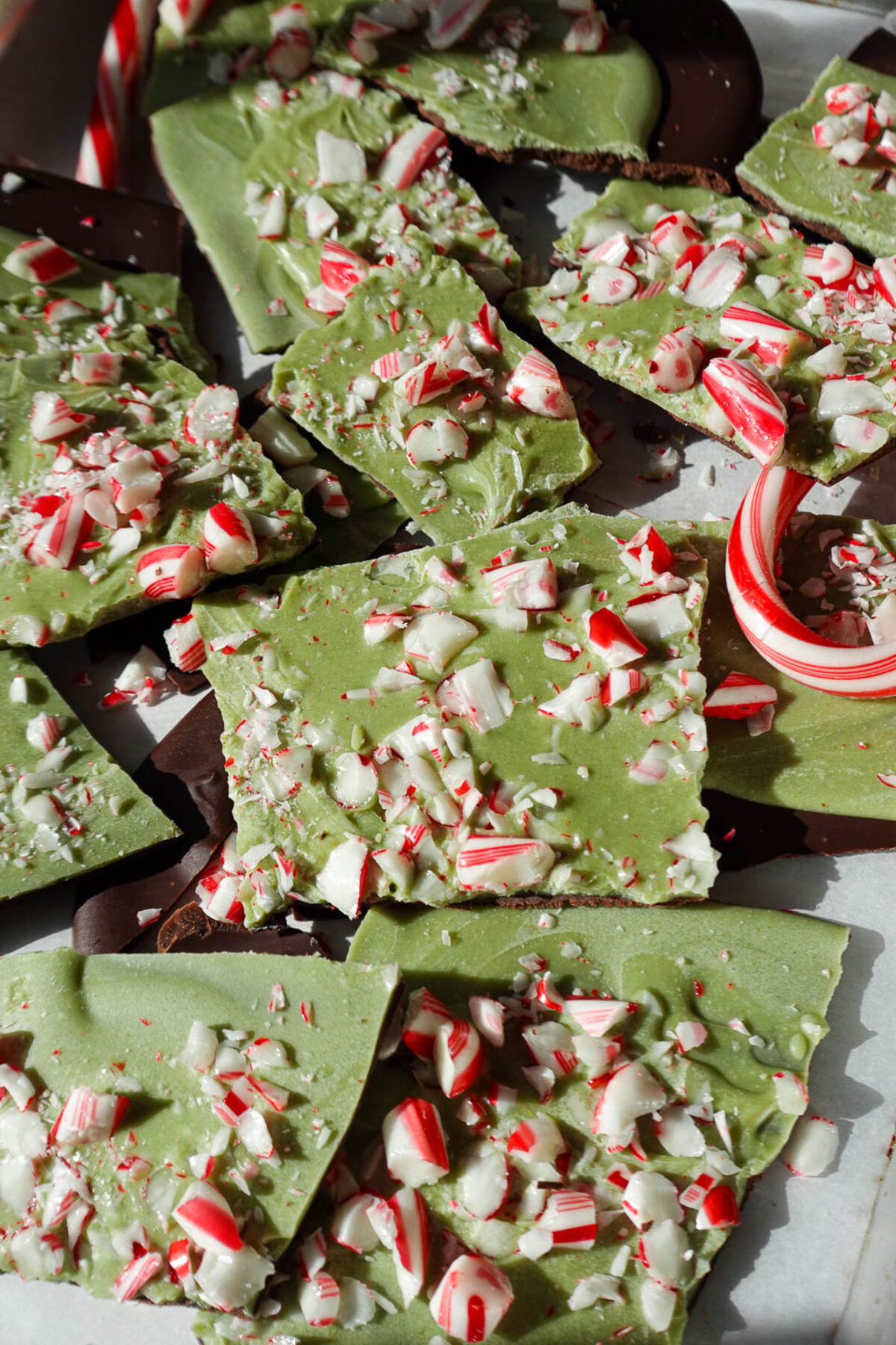 Vegan matcha peppermint bark broken into pieces with candy canes