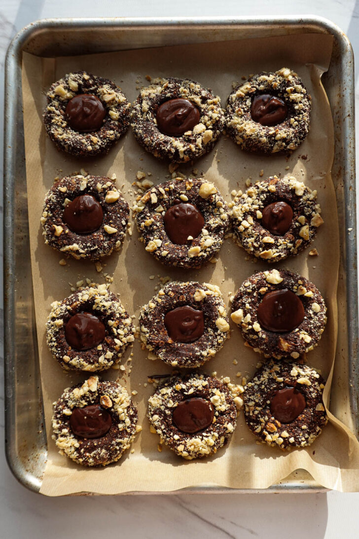 Chocolate hazelnut butter filled in the center of a thumbprint cookie