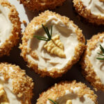 cutely decorated healthy carrot cake muffins topped with high-protein vegan cream cheese frosting. gluten-free, too!