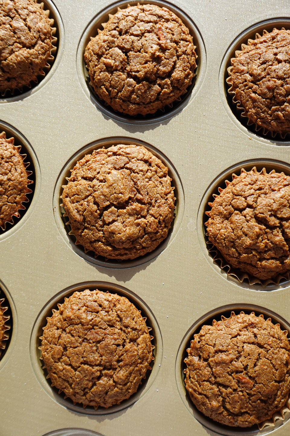 freshly baked carrot cake muffins in muffin tin