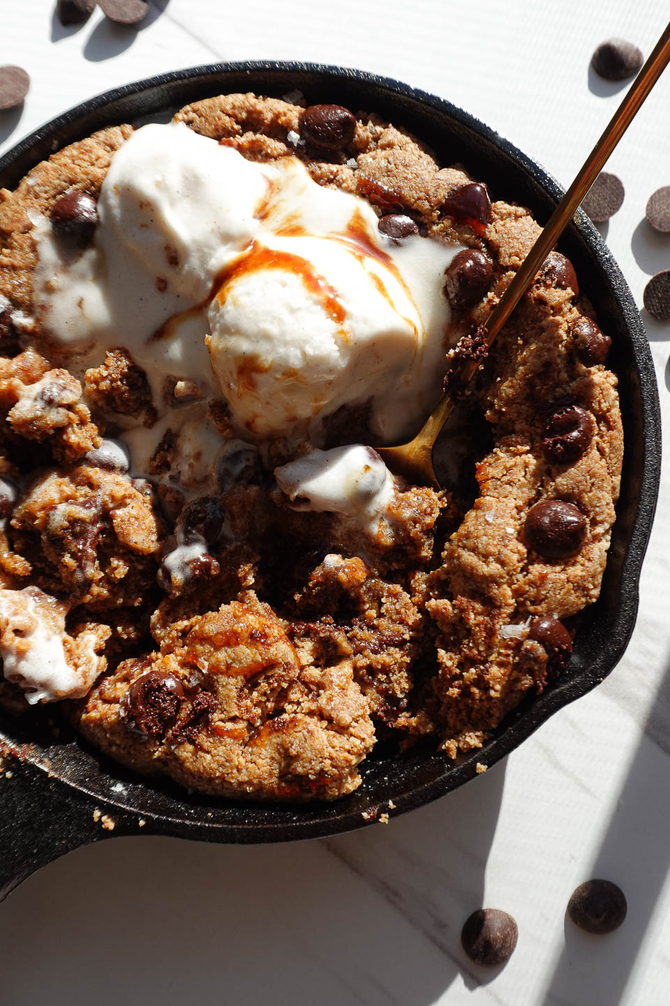 Close-up of a soft and chewy chocolate chip skillet cookie with a gooey center