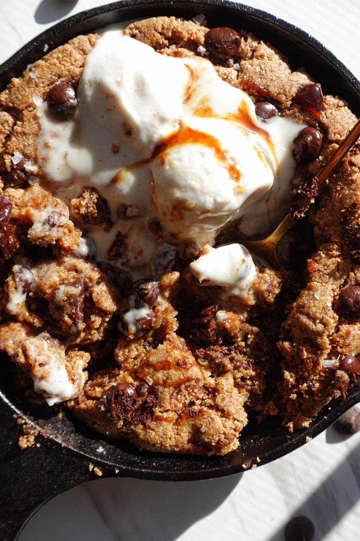 Close-up of a soft and chewy chocolate chip skillet cookie with a gooey center