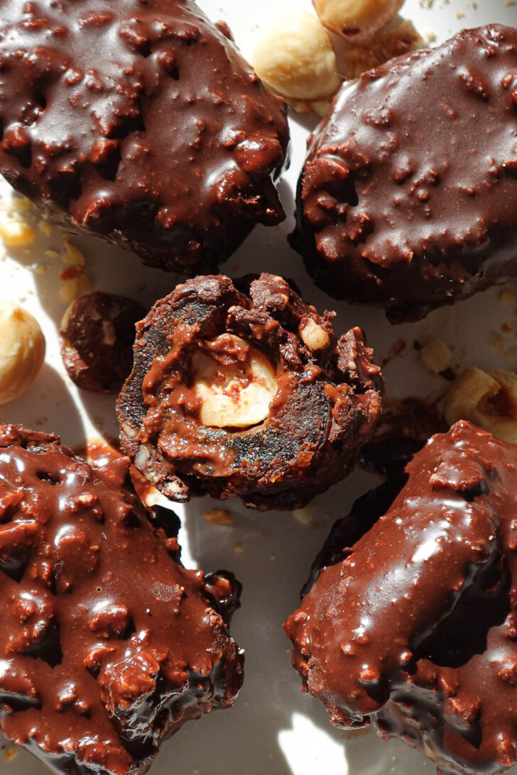 Inside view of ferrero rocher stuffed date showing creamy hazelnut butter and a whole hazelnut