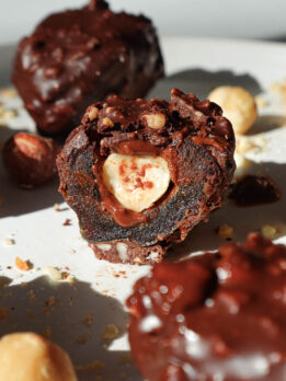 Inside view of ferrero rocher stuffed date showing creamy hazelnut butter and a whole hazelnut