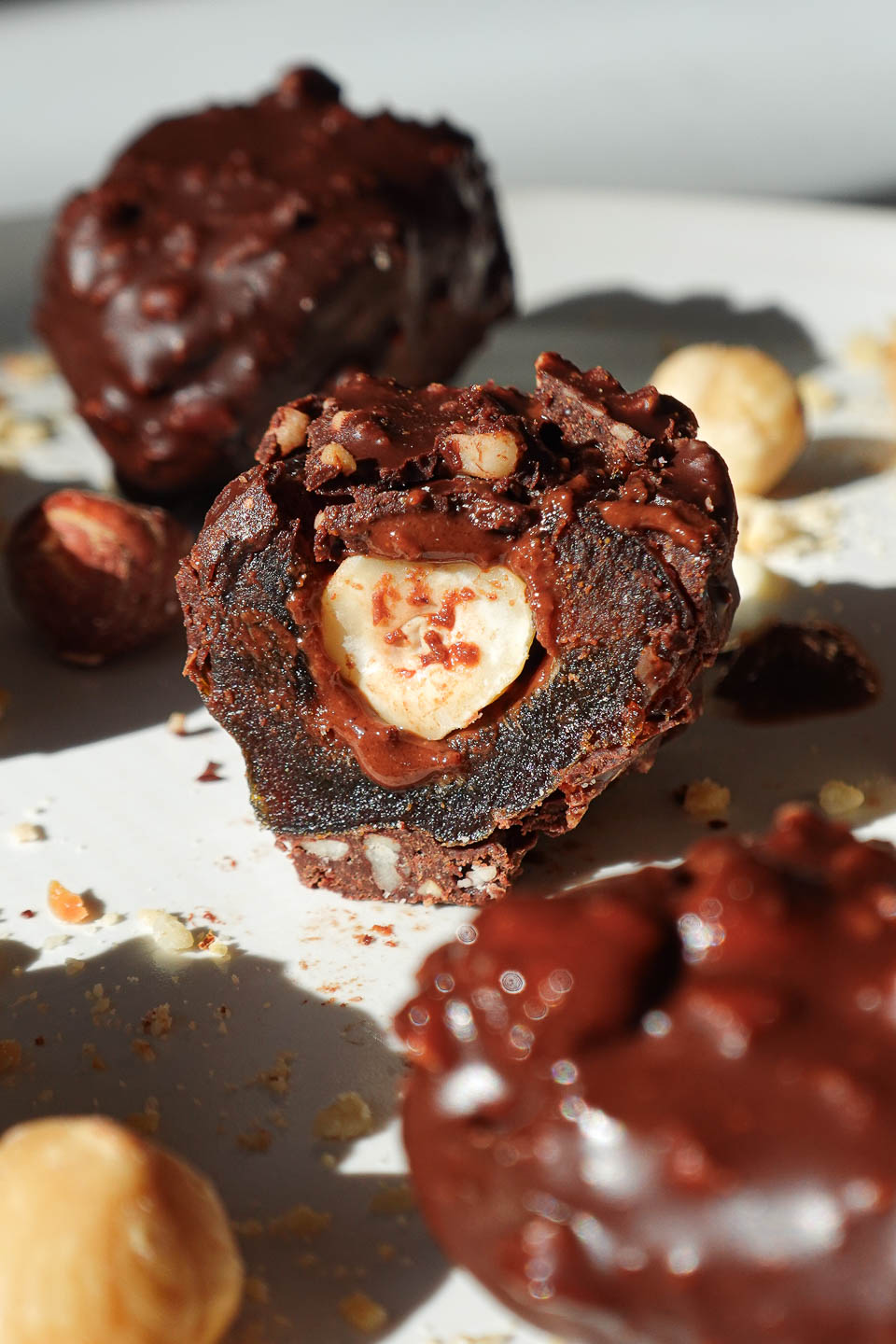 Inside view of ferrero rocher stuffed date showing creamy hazelnut butter and a whole hazelnut