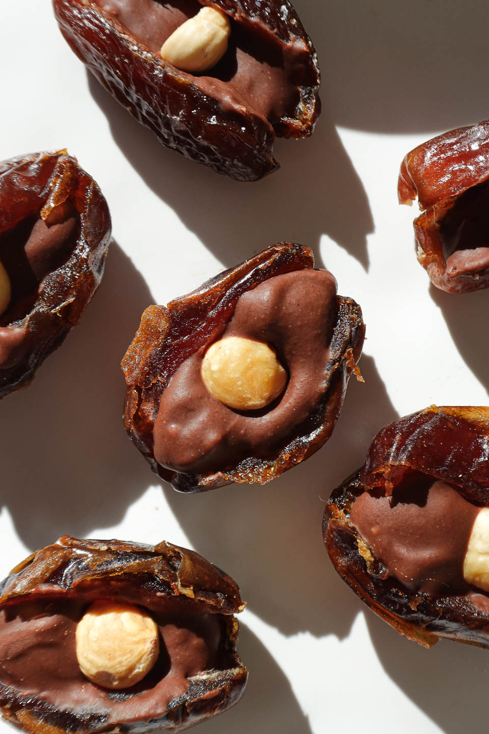 Chocolate hazelnut stuffed dates ready to be dipped in melted dark chocolate.