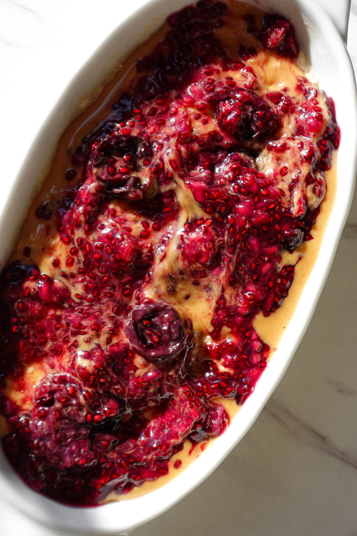 Peanut butter & jelly overnight oats topped with peanut butter and chia jam