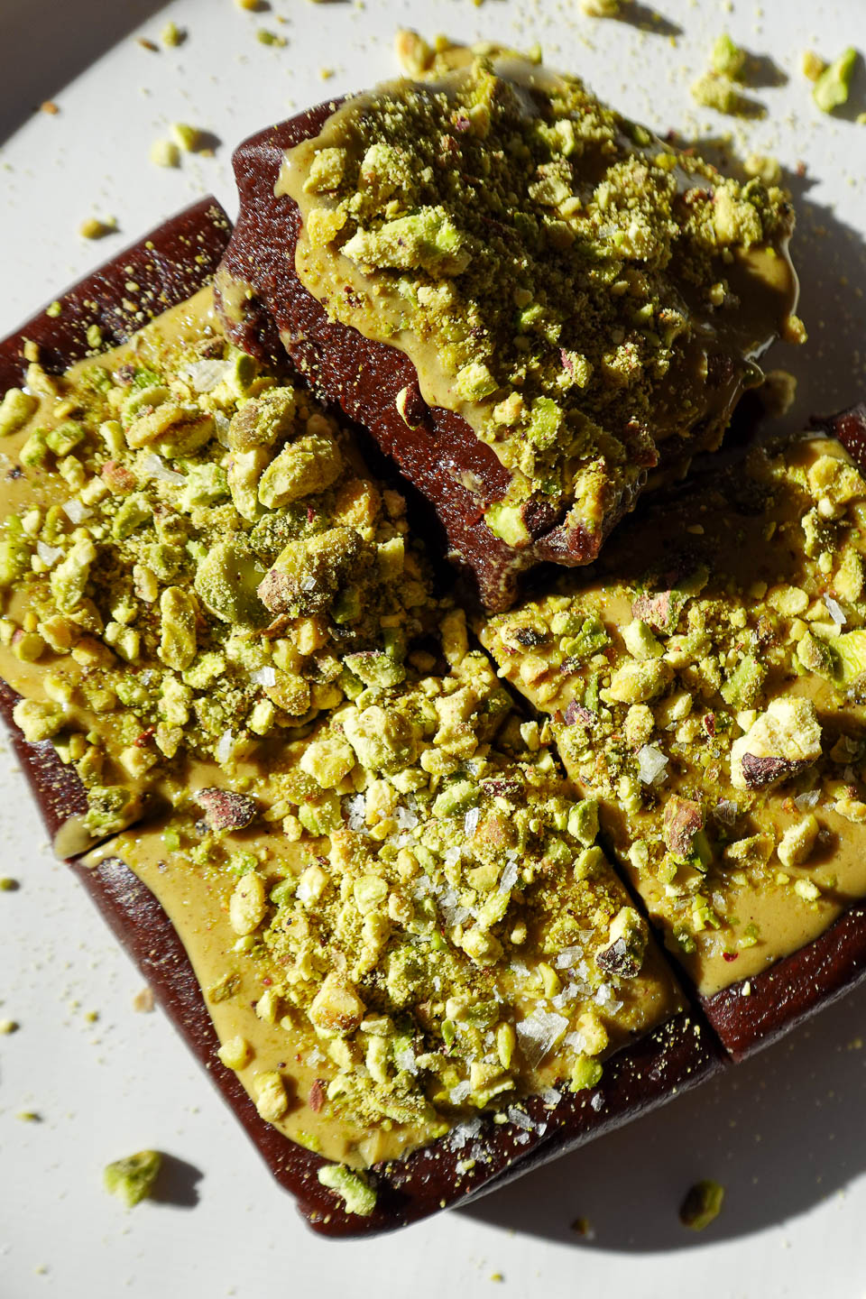 No bake pistachio brownies topped with pistachio butter and chopped pistachios