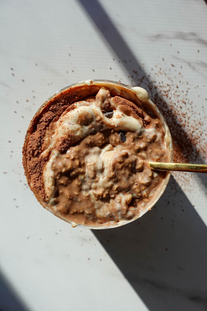 Thick and creamy tiramisu oats with cocoa powder on top