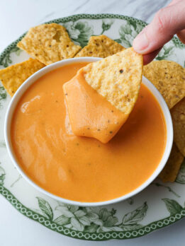 Creamy dairy-free cheese sauce served as a queso dip with tortilla chips