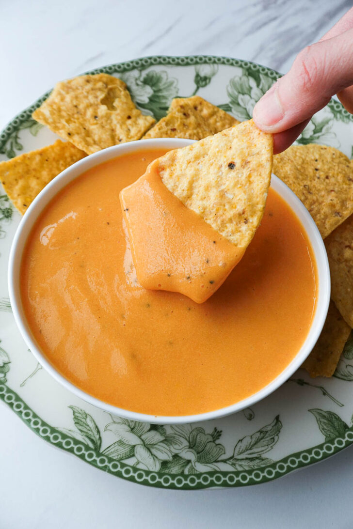 Creamy dairy-free cheese sauce served as a queso dip with tortilla chips