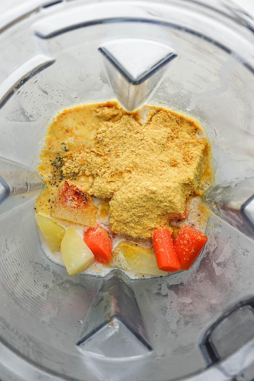 Blending dairy-free cheese sauce made from vegetables