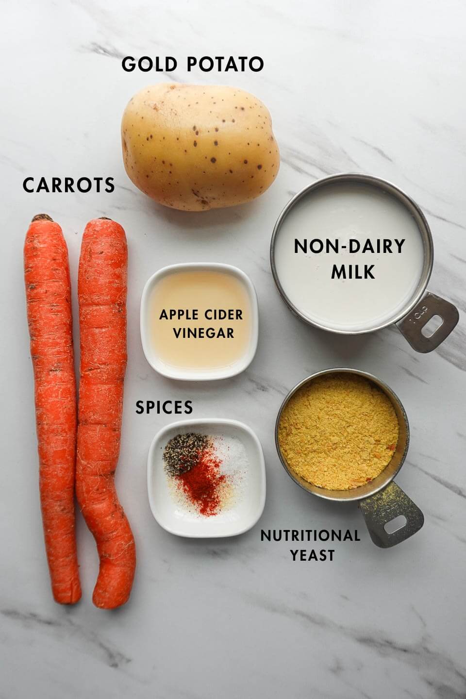 Ingredients for vegan cheese sauce including potatoes, carrots, and nutritional yeast