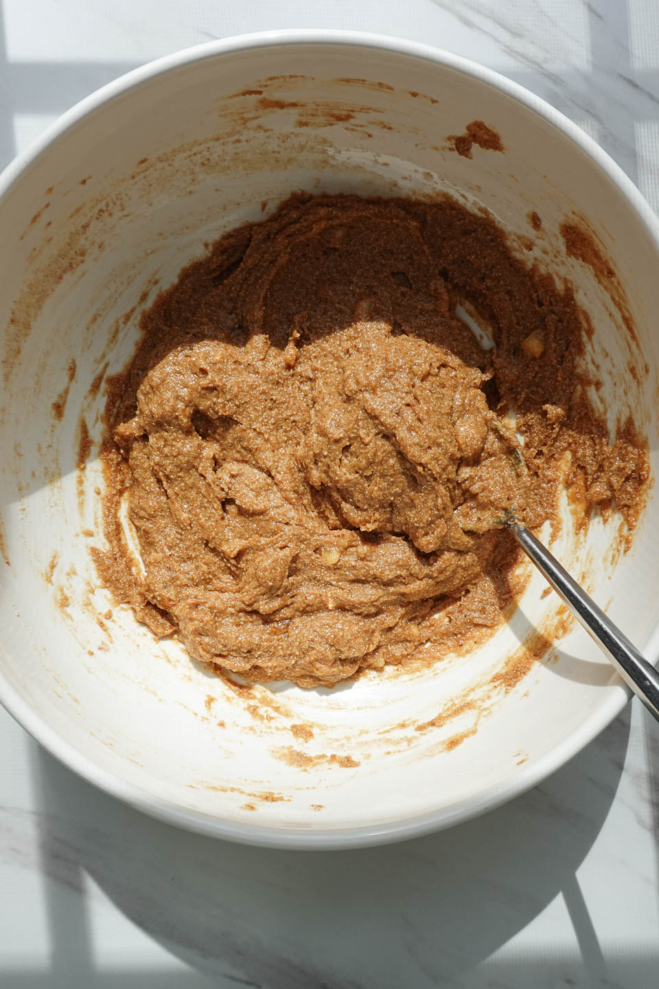 mixing dry ingredients into banana bread cookie mixture