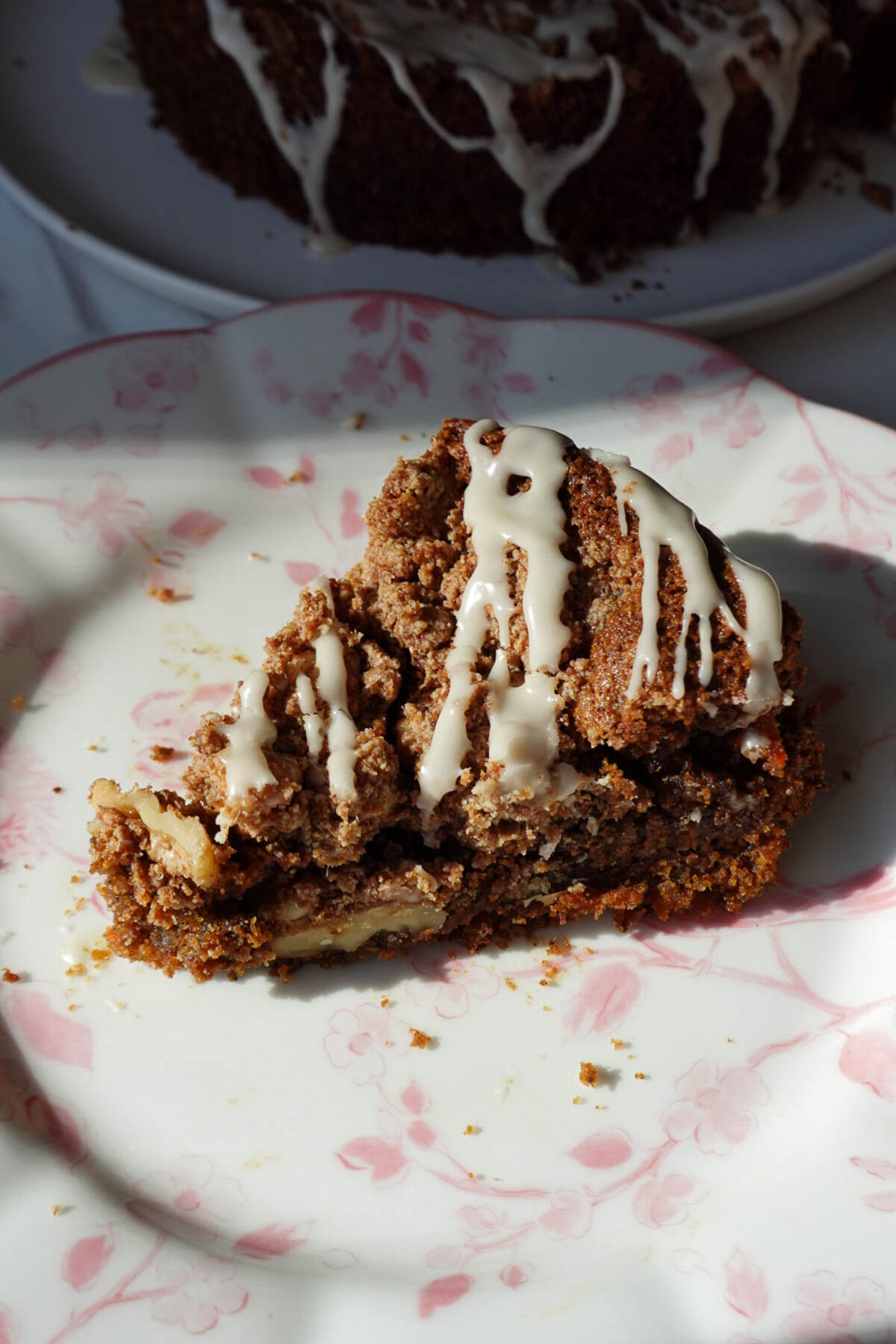 Slice of vegan carrot cake coffee cake showing moist texture and crumb topping