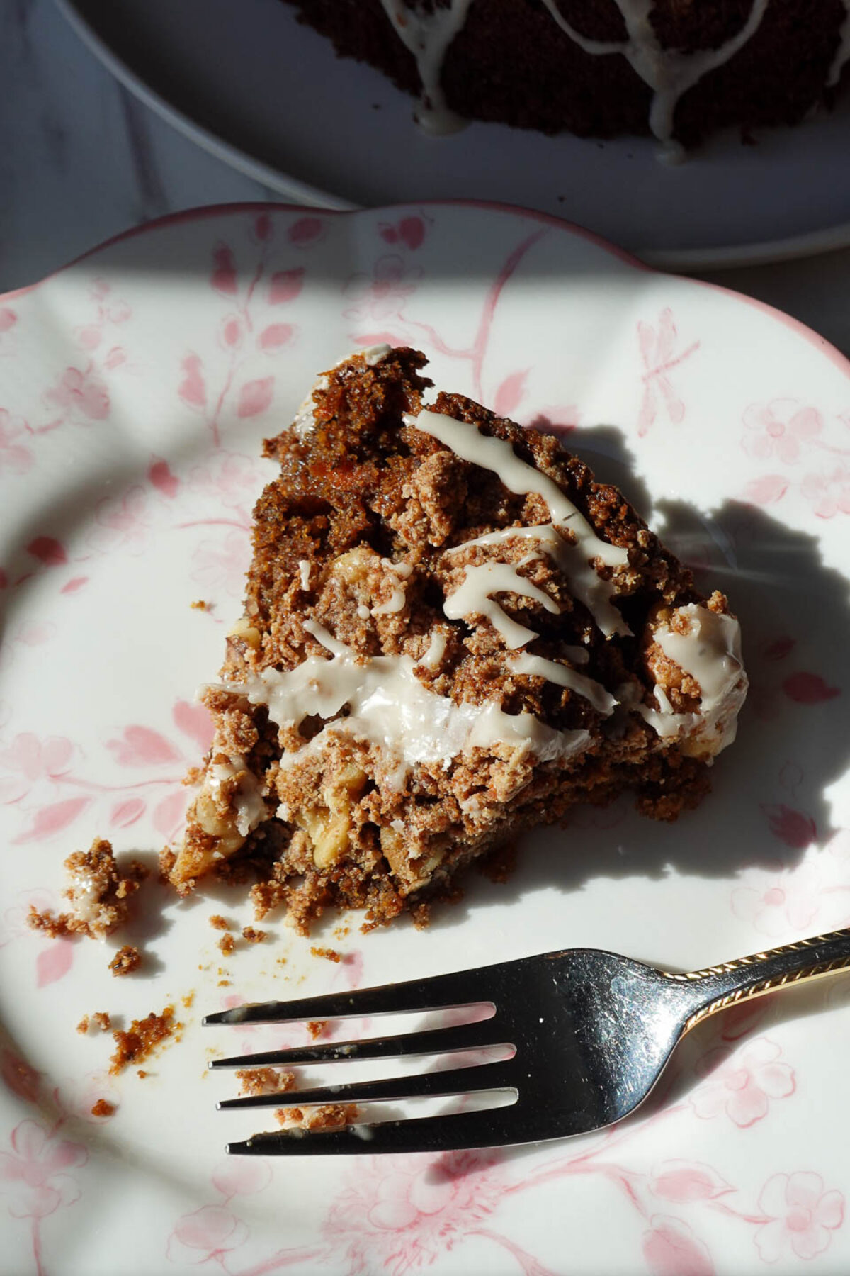Fork cutting into soft and moist vegan carrot cake coffee cake slice