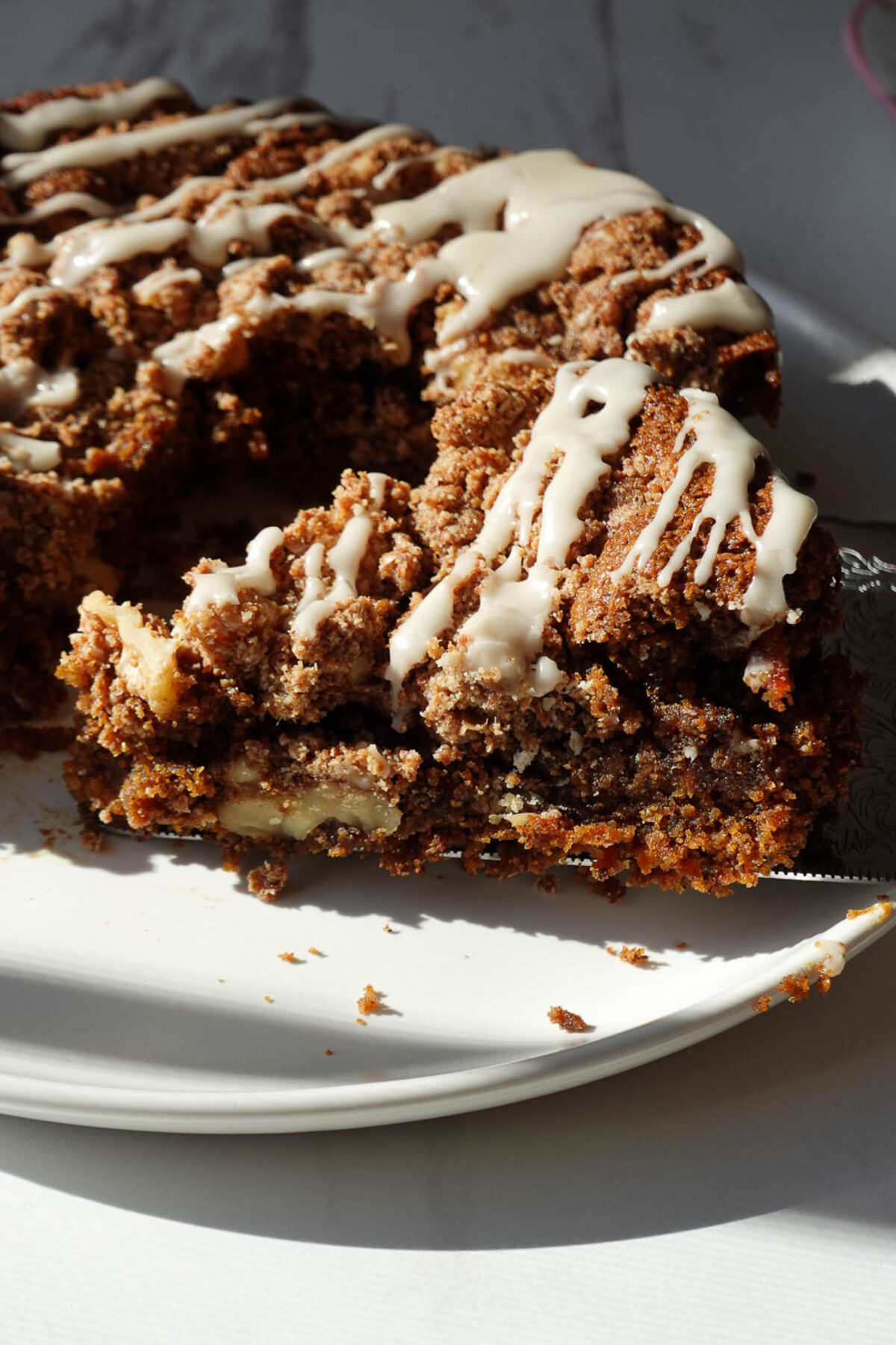 Close-up of carrot cake coffee cake with walnut crumble and icing