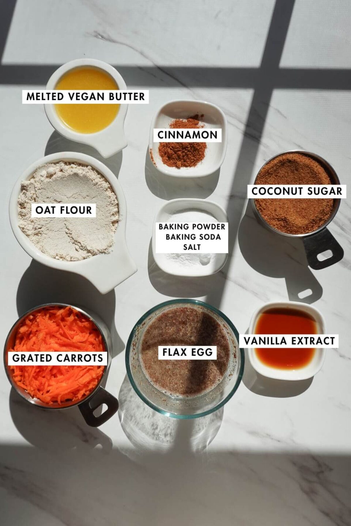 Ingredients for vegan carrot cake coffee cake including oat flour, carrots, coconut sugar, and walnuts
