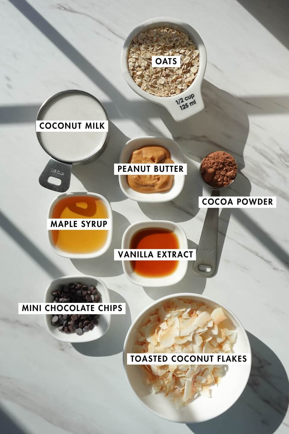 Ingredients for Samoas overnight oats including quick oats, coconut milk, cocoa powder, and peanut butter
