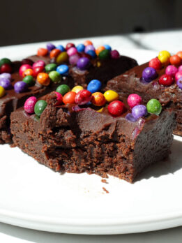 No bake cosmic brownie with a bite taken out, showing it's fudgy texture.