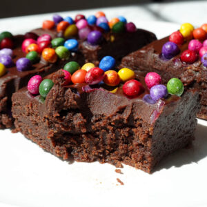 No bake cosmic brownie with a bite taken out, showing it's fudgy texture.