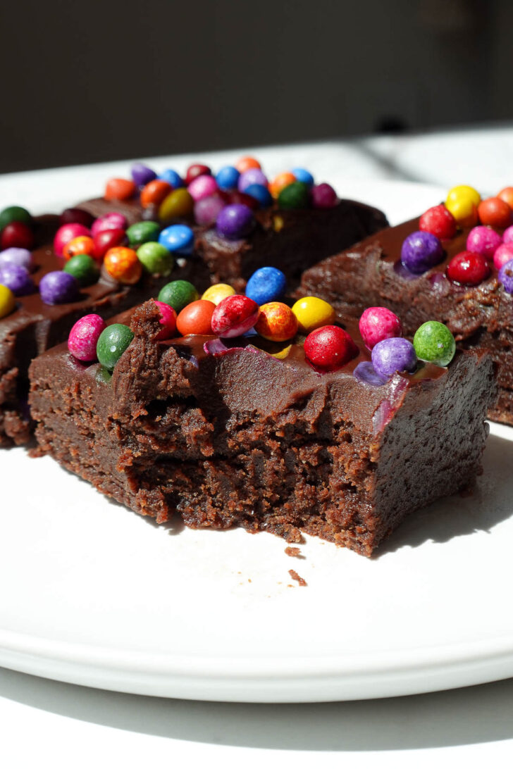No bake cosmic brownie with a bite taken out, showing it's fudgy texture.