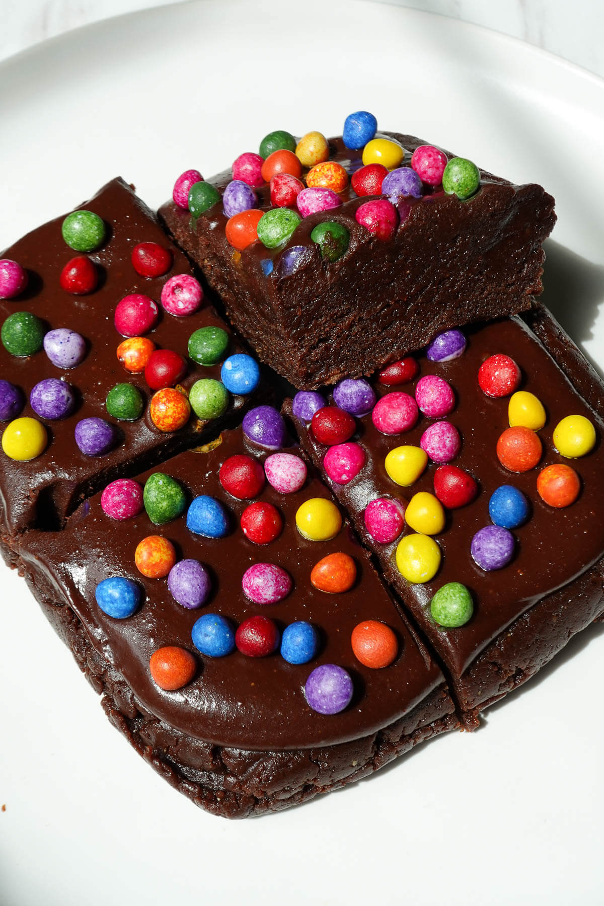 Close-up of no bake vegan cosmic brownies showing their moist and fudgy texture.