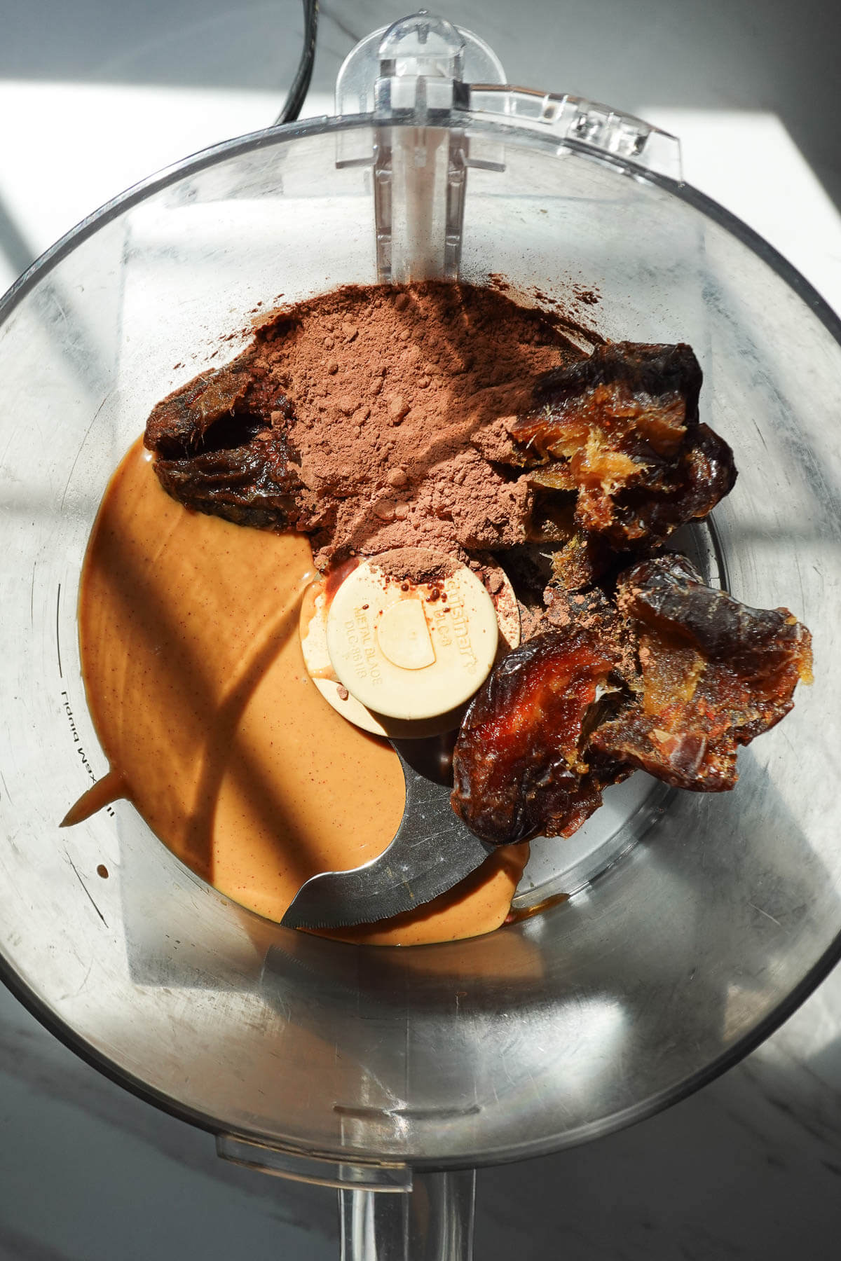 Ingredients to make no bake cosmic brownies in a food processor before blending