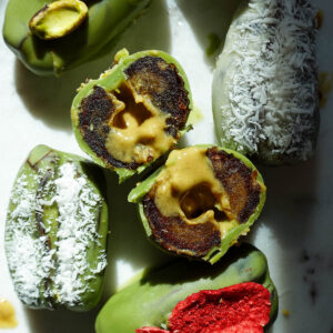 Inside of pistachio matcha stuffed date showing the creamy center.