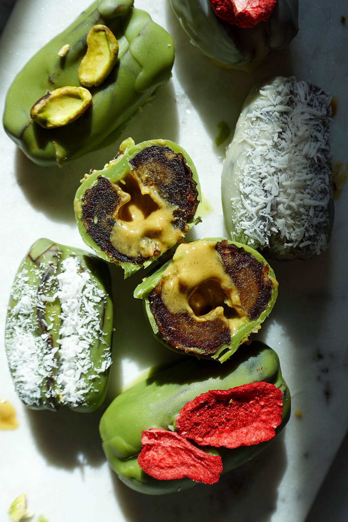 Inside of pistachio matcha stuffed date showing the creamy center.