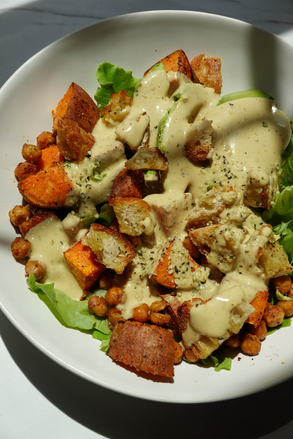 Sweet potato chickpea salad tossed in a creamy vegan honey mustard dressing.