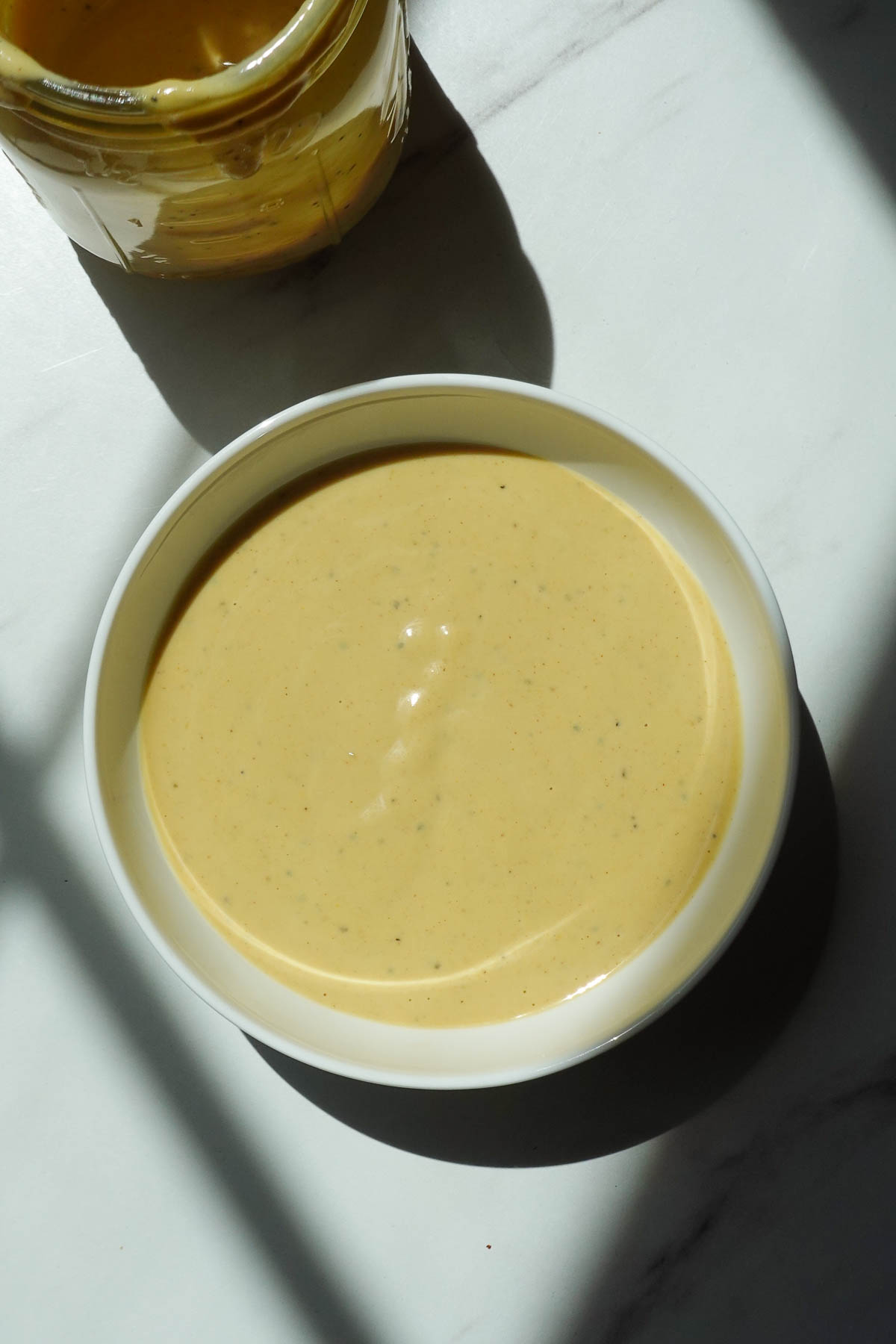 Creamy vegan honey mustard dressing in a bowl.