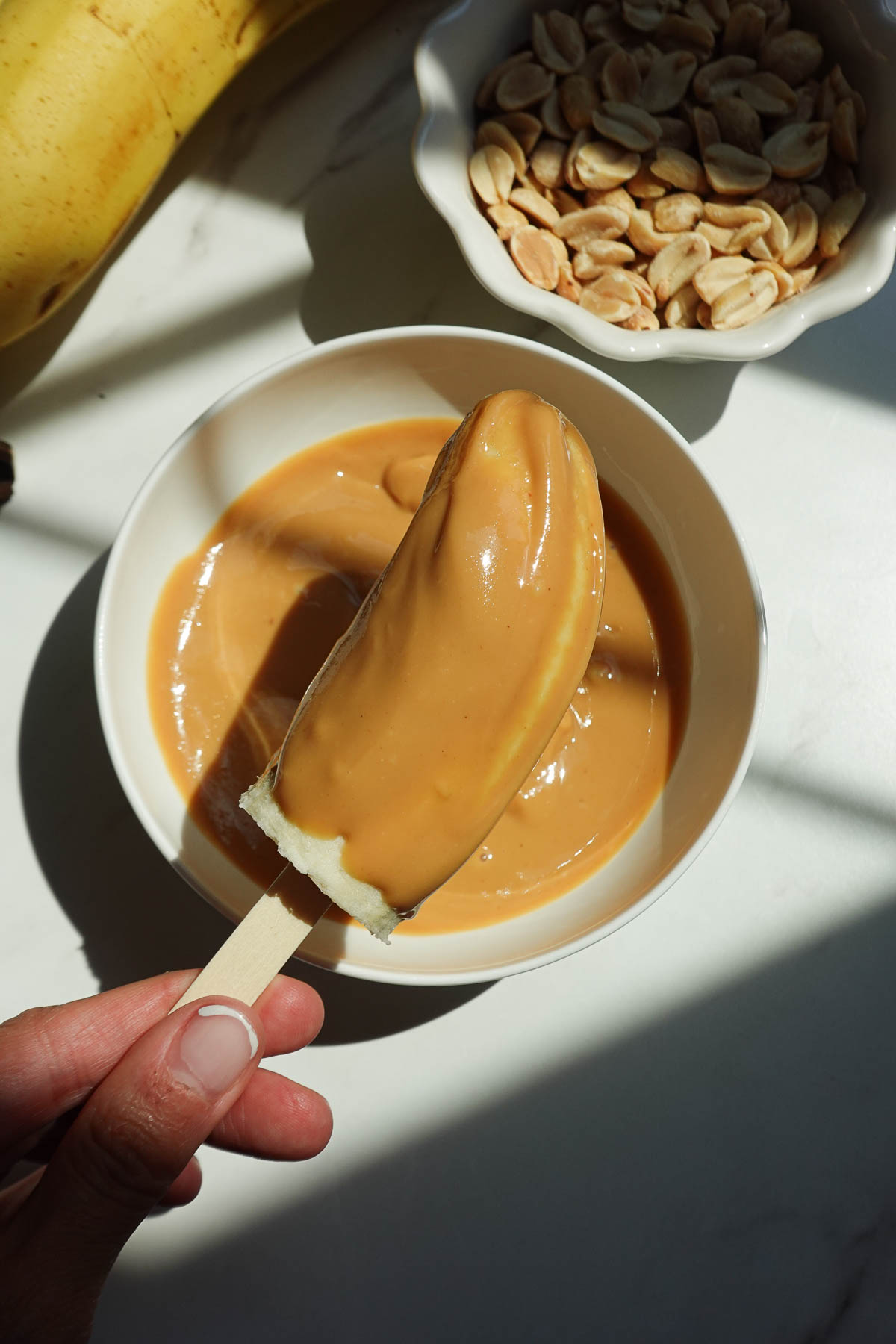 Spreading peanut butter onto banana halves.