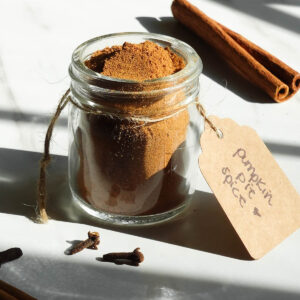 Homemade pumpkin pie spice in a small glass jar.