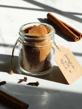 Homemade pumpkin pie spice in a small glass jar.