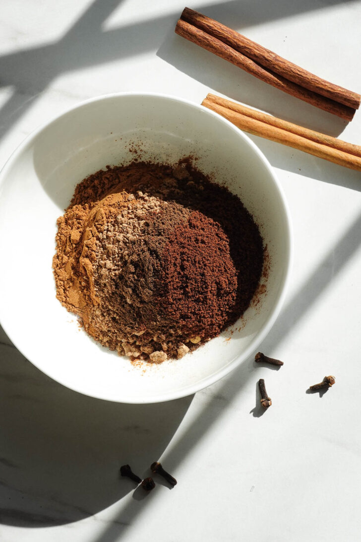 Five spices in a bowl to make homemade pumpkin pie spice.