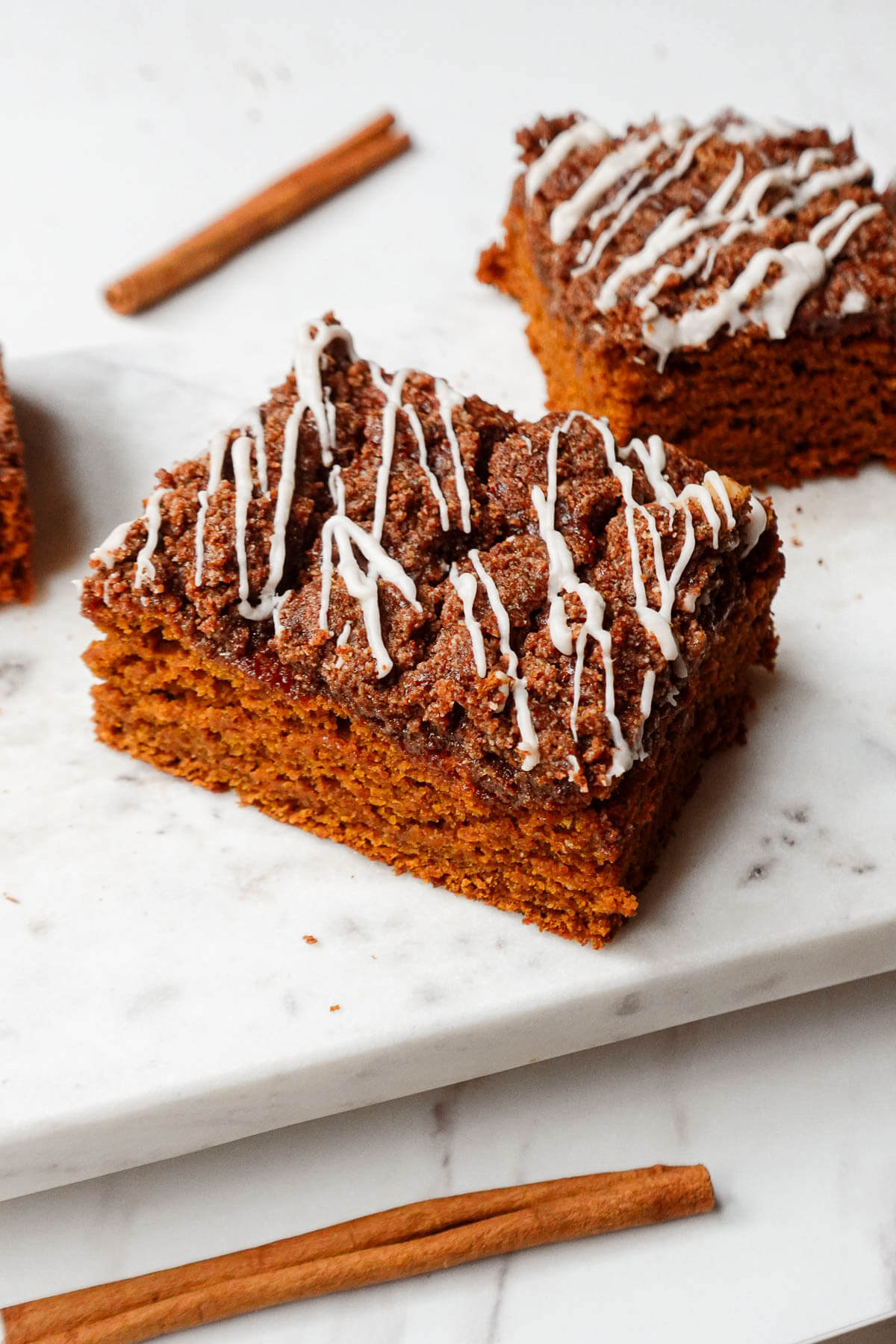 Vegan pumpkin coffee cake on a marble plate.