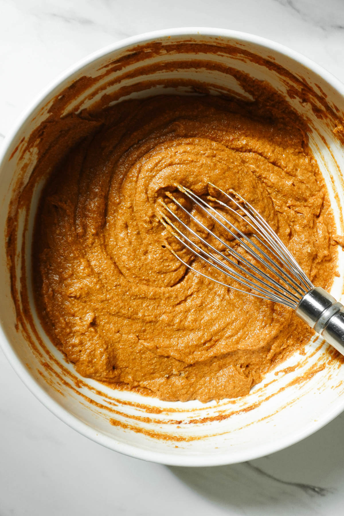 Whisking pumpkin coffee cake batter.