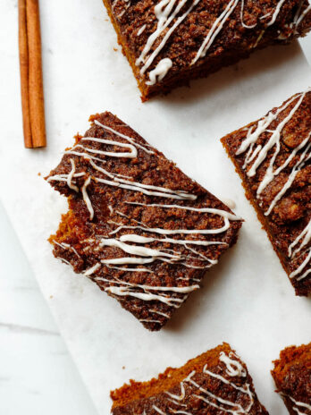 Slice of vegan pumpkin coffee cake with a bite taken out of it.