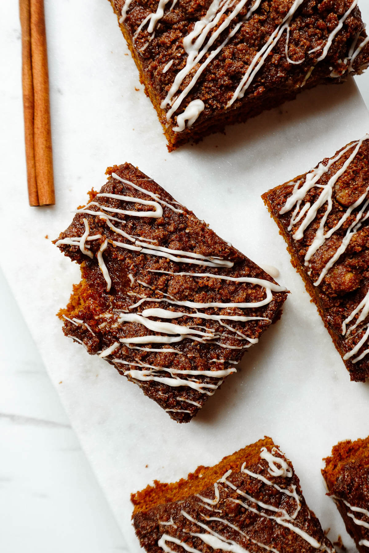 Slice of vegan pumpkin coffee cake with a bite taken out of it.